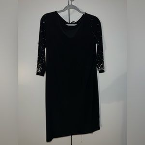 Very gorgeous black dress with pearl details. Not bodycon loose like material